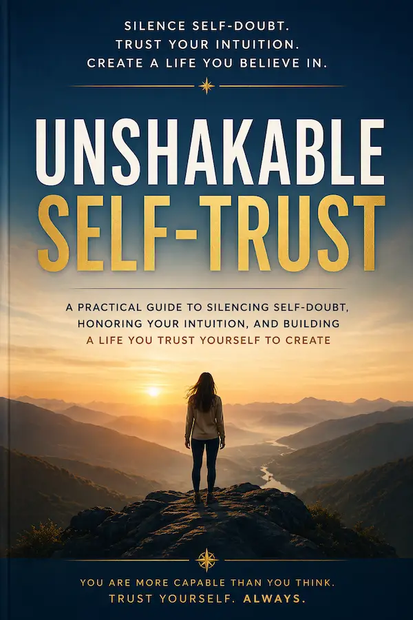 A woman standing on a mountain peak at sunrise, symbolizing confidence, clarity, and inner strength